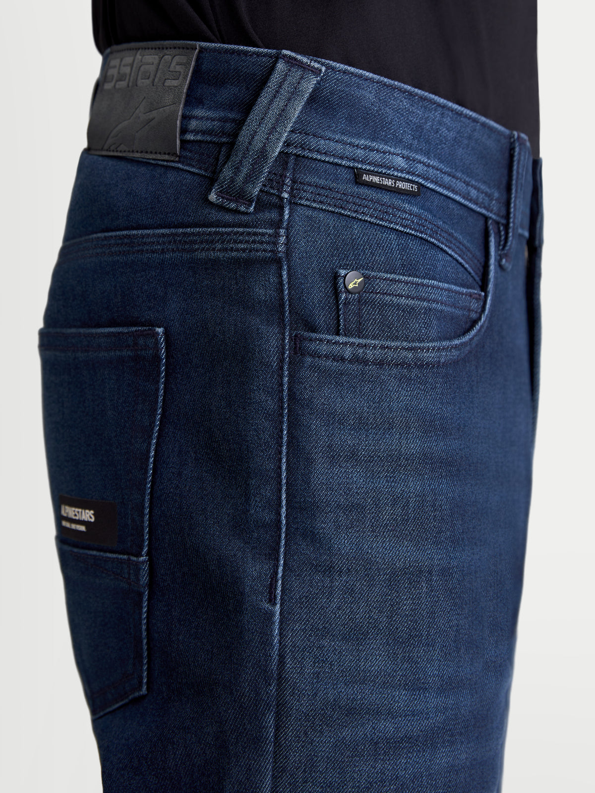 Alpinestars Flex-AST 10 Tough Max Denim Pants, men's motorcycle riding jeans in dark blue, close-up view highlighting the five-pocket layout, leather rear patch, and branded trim details