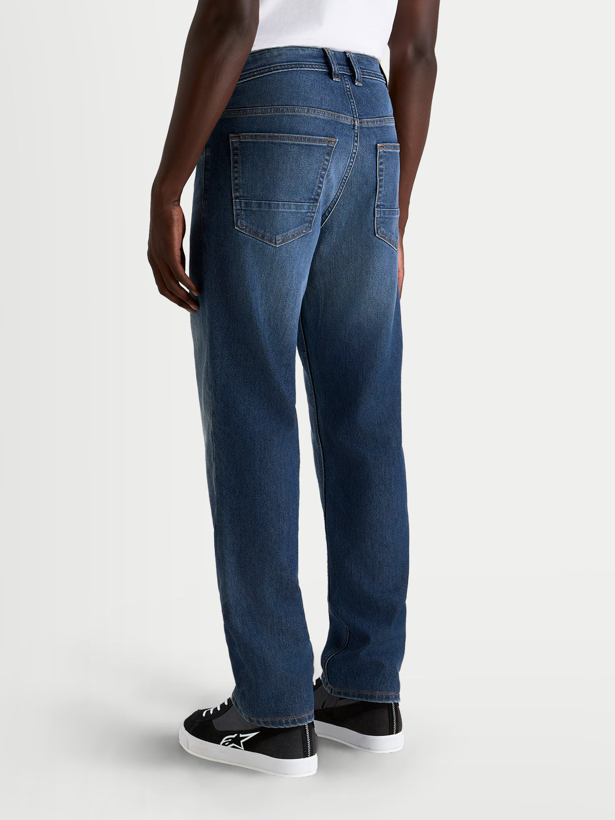 Alpinestars Flex-AST 8 Denim Pants Short, men's urban motorcycle riding jeans in medium blue, rear view showing five-pocket construction and straight-leg fit on a model