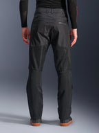 Alpinestars C-1 Air Pants, back view, Black, urban textile motorcycle pants featuring large tech mesh panels on the back of the legs for ventilation, clean design with subtle branding, worn with a black base layer and casual riding shoes.