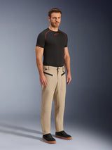 Alpinestars Flex-AST Canvas Pants, Urban Motorcycle Pants, Tan Brown, featuring heritage workwear styling with zippered front pockets and ergonomic knee panels, worn with black sneakers and a black t-shirt, contemporary urban riding gear