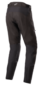 Alpinestars Venture XT Pants In Boot, Black Adventure Touring Pants, Rear three-quarter view showing water-resistant textile construction, PU film reinforcements on the inner leg, adjustable waistband with white star logo, designed for dual-sport motorcycle riding