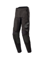 Alpinestars Venture XT In Boot Pants, Men's Adventure Touring Motorcycle Pants, Black, front three-quarter view featuring water-resistant textile construction, zippered thigh pocket with Astars logo, and reinforced knee panels.