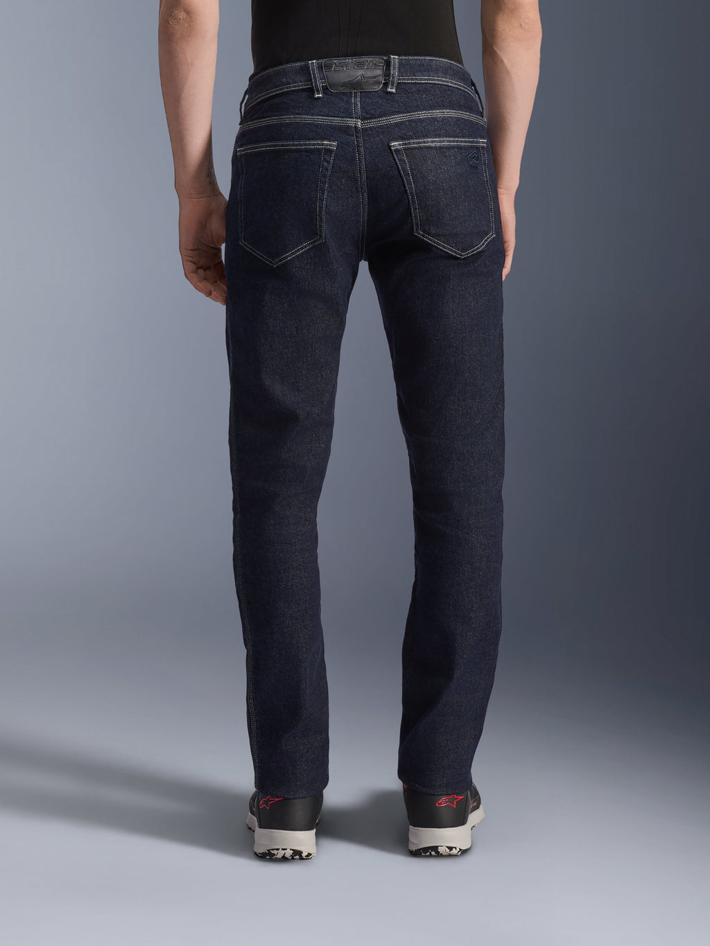 Alpinestars Copper V3 Denim Pants, Motorcycle Riding Jeans in Rinse Blue, back view showing regular straight leg fit, dual rear pockets with contrast white stitching, dark indigo stretch denim with logo patch on the waistband.