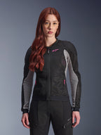 Alpinestars Woman Stella Troop-Air Jacket, Women's Motorcycle Mesh Jacket, Black Ash Gray and Pink Fluo, worn by a model with matching riding pants, featuring ventilated 2D tech mesh construction and pink logo detail, designed for urban summer riding.