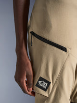 Alpinestars Stella Flex-AST Explorer Pants, Women's Motorcycle Pants, Sand, close-up detail of zippered cargo pocket and black ALL TERRA logo patch, durable ripstop textile construction for adventure touring