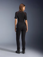 Alpinestars Women's Banshee Leggings, Black motorcycle leggings, back view showing figure-hugging fit and anatomical stretch fabric, featuring back pockets and logo detail, worn with a black base layer and riding shoes, urban motorcycle gear for women