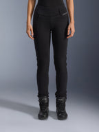 Alpinestars Womens Banshee Leggings, Black motorcycle pants, slim-fit design with accordion knee panels, worn with black high-top riding boots, urban road gear with a casual style