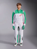 Alpinestars KMX-9 V3 Graphic 6 Suit, White Green and Red, one-piece karting suit featuring a black splatter graphic pattern, green panels on sleeves and legs, red Alpinestars chest logo, worn with matching racing gloves and shoes