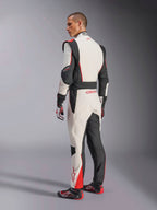 Alpinestars GP Tech V4 Suit, White Black Red racing suit, rear view showing ergonomic stretch panels on the lower back and legs, paired with matching racing gloves and shoes, professional motorsport apparel.
