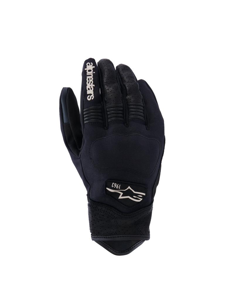 Alpinestars Tracker Gloves, Motorcycle Gloves, Black, backhand view showing stretch textile construction, perforated leather details on fingers and wrist, white branding on index finger, Alpinestars logo with 1963 on the back, padded knuckle area, short cuff urban design