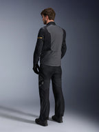 Alpinestars ST-7 2L GORE-TEX Jacket, Deep Gray and Black with Dark Khaki accents, rear view of a rider wearing the jacket and matching motorcycle pants, adventure touring gear with waterproof laminated construction
