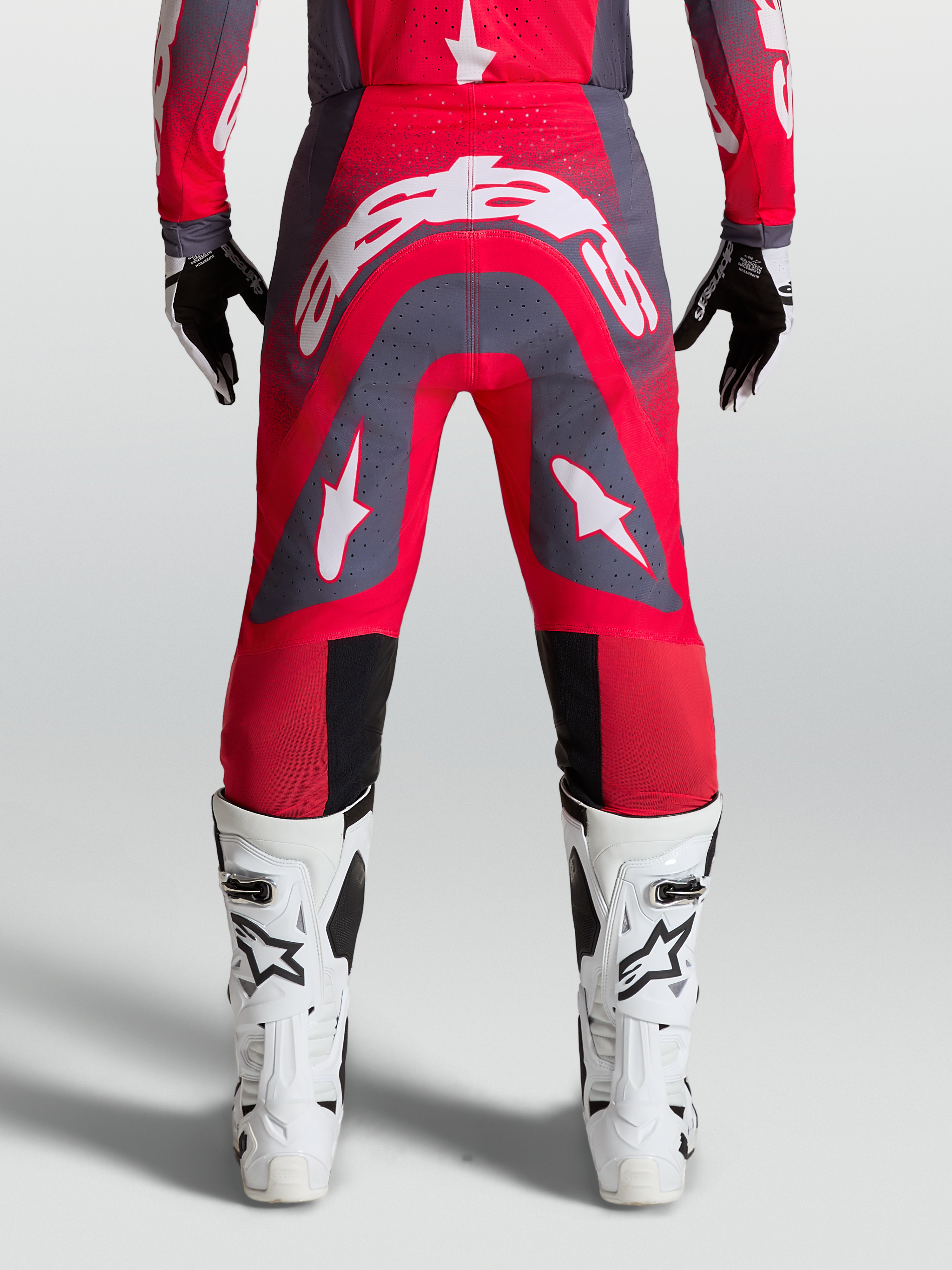 Alpinestars Supertech Hiten AFD Pants, professional motocross racing gear in Red Fluo and Graystone with white logos.