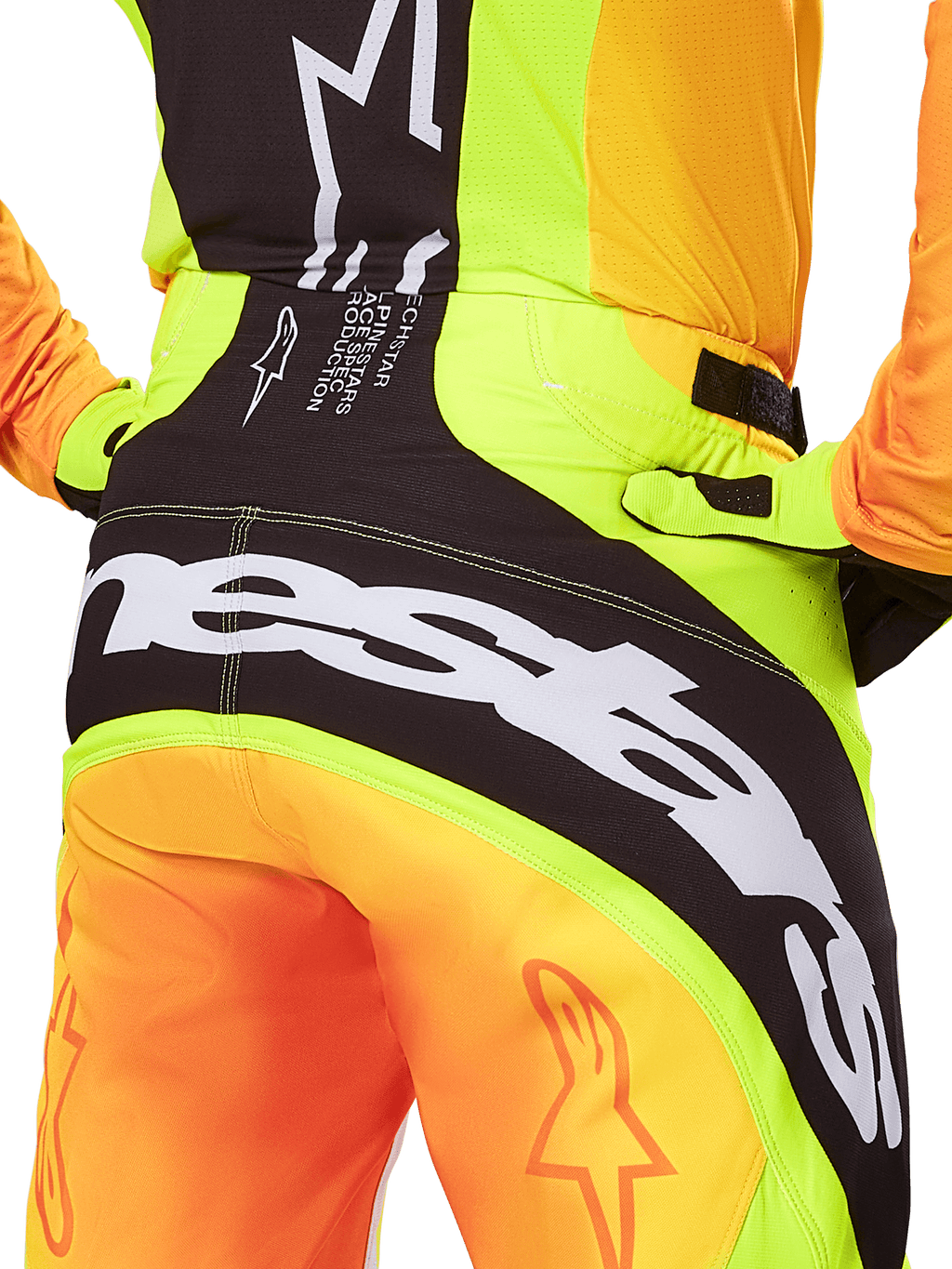 Alpinestars 2025 Techstar Melt Pants, Motocross Pants, Rear view close-up, Neon Yellow and Orange with Black panels, large white Alpinestars branding across the seat, performance off-road riding gear