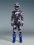 Alpinestars 2026 Racer Lahnd Gear Set, Motocross Outfit, Black and White with Iron Camo abstract pattern, paired with blue and white helmet and bright blue boots, complete racing kit for off-road performance