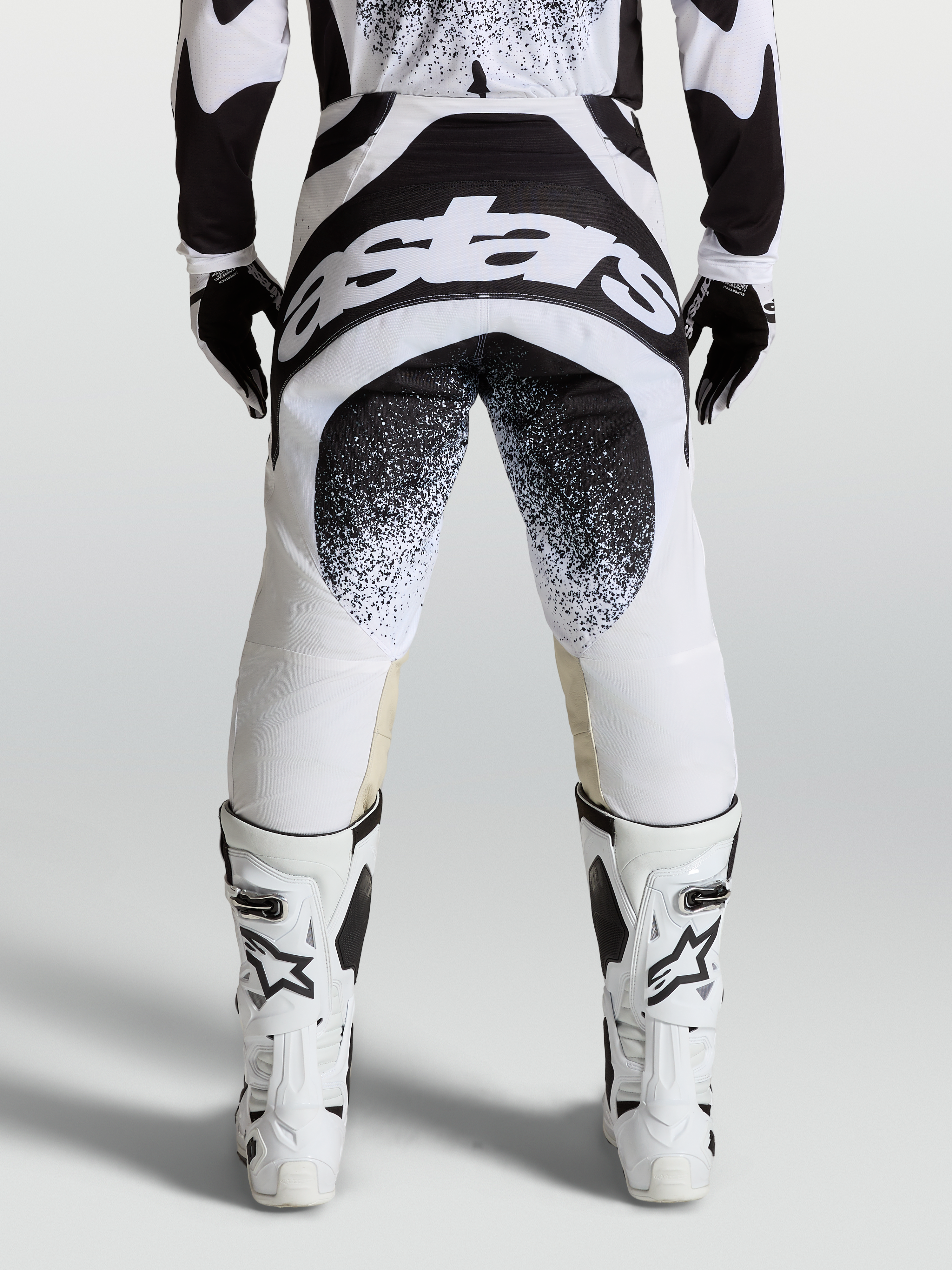 Alpinestars Techstar Swan Pants, professional motocross racing pants in black and white with rear logo graphics and Babel knee construction.