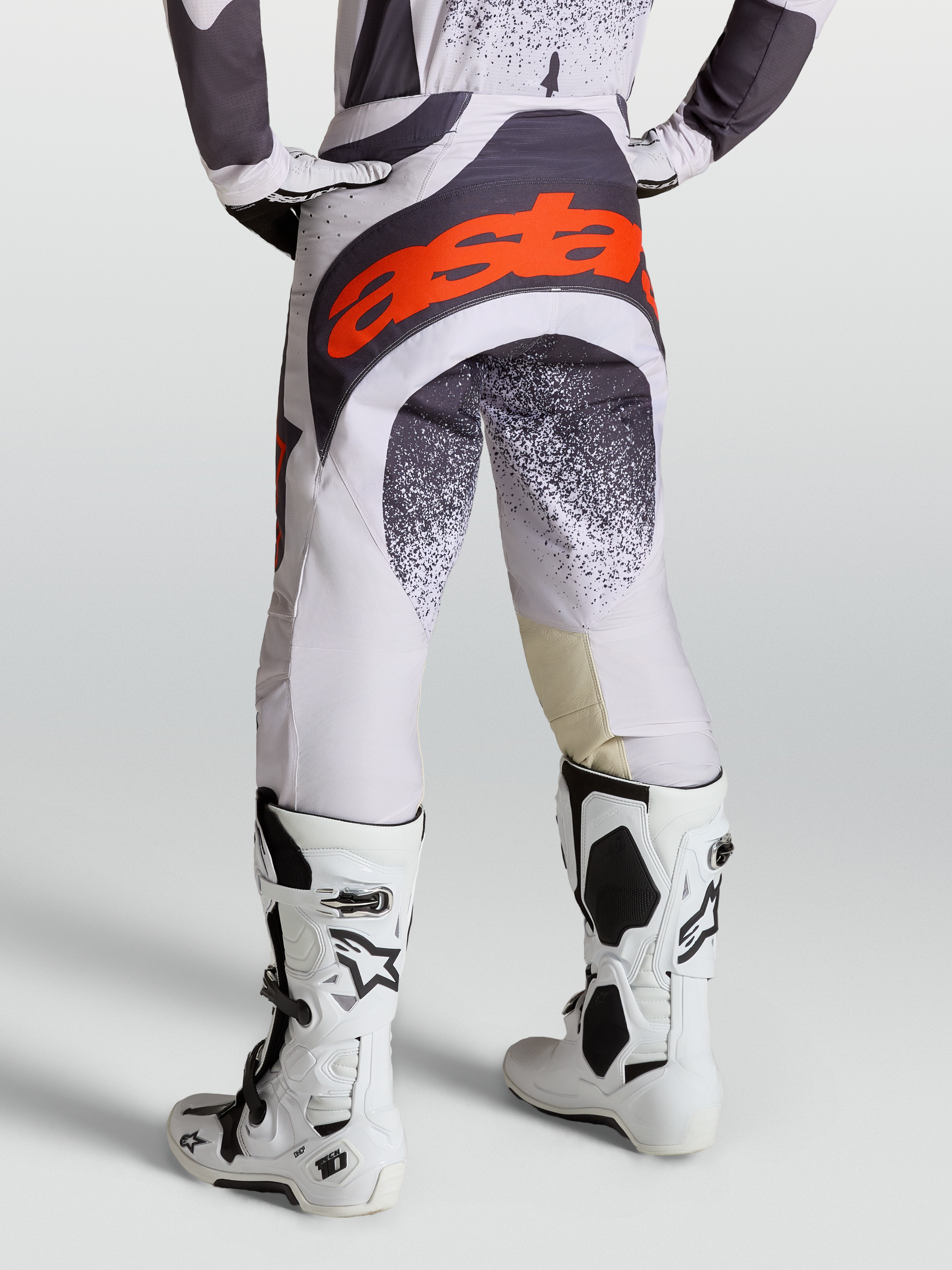 Alpinestars Techstar Swan Pants, Motocross Racing Pants for Men, Light Lilac and Dark Gray, Red Fluo accents, with Tech 10 boots.