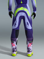 Alpinestars 2026 Supertech Scenz Pants, Motocross Pants, Purple and Yellow Fluo, rear view showing large yellow logo on seat, worn with matching jersey, gloves, and protective boots, athletic fit for professional motocross racing.