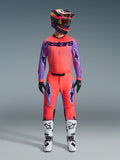 Alpinestars 2026 Supertech Scenz Pants, Motocross Pants, Hot Coral and Purple, worn as a complete gear set with matching jersey and helmet, white and black boots, featuring purple logos and athletic racing fit.