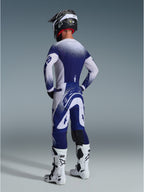 Alpinestars 2026 Supertech Scenz Pants, Motocross Pants, Light Gray and Dark Blue, rear view worn with matching jersey and white boots, featuring gradient dot graphics and performance athletic fit for off-road racing.