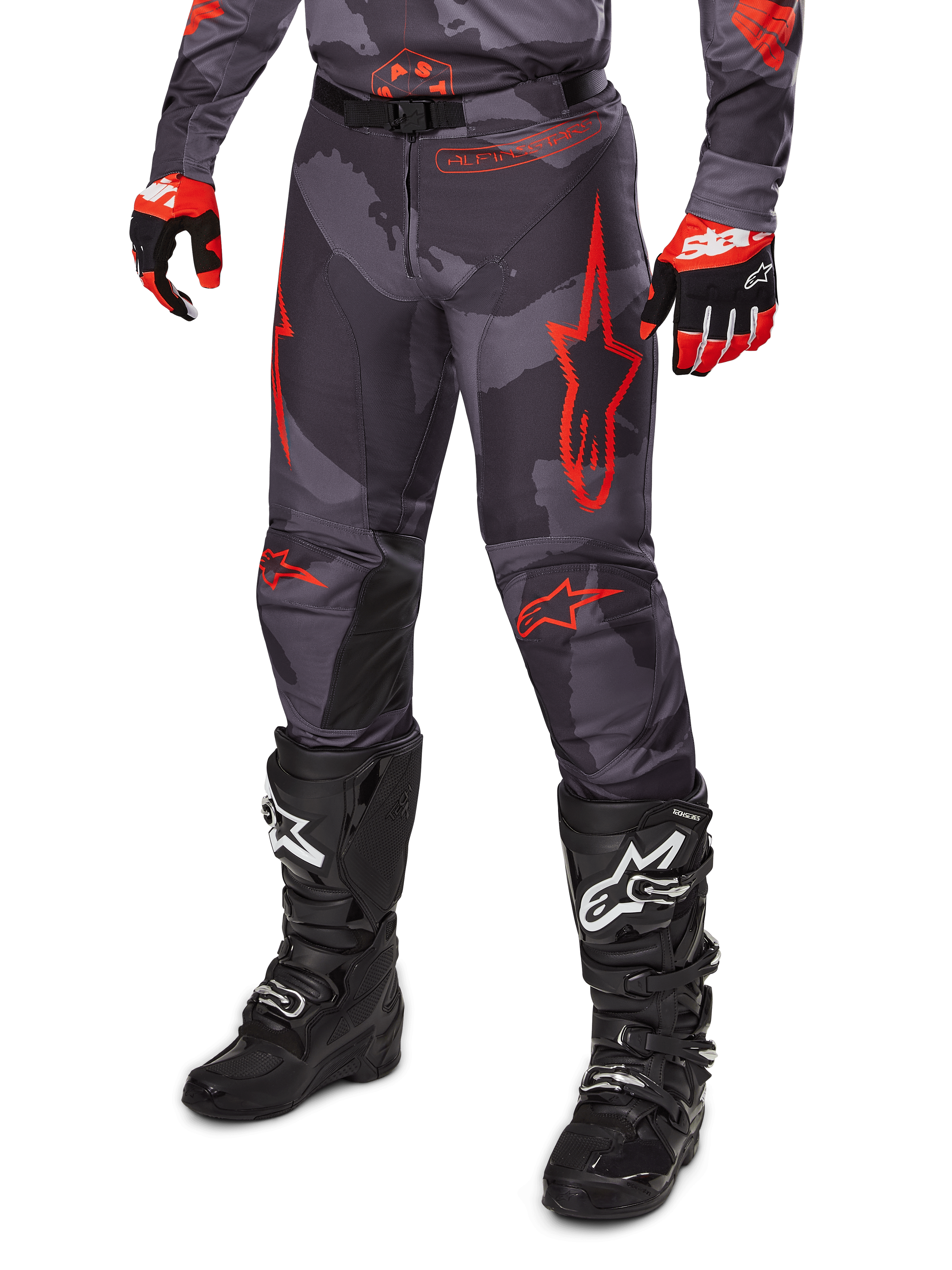 Alpinestars 2025 Racer Hollow Pants, Motocross Pants, Gray Camo and Red, worn with black boots and red gloves, featuring bold red star logos, camouflage pattern, and durable protective panels for off-road riding