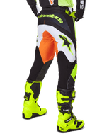 Alpinestars 2025 Fluid Wurx Pants, Motocross Pants, Yellow and Black with orange and white accents, back view worn with matching bright yellow boots, durable construction with bold branding for dirt bike riding