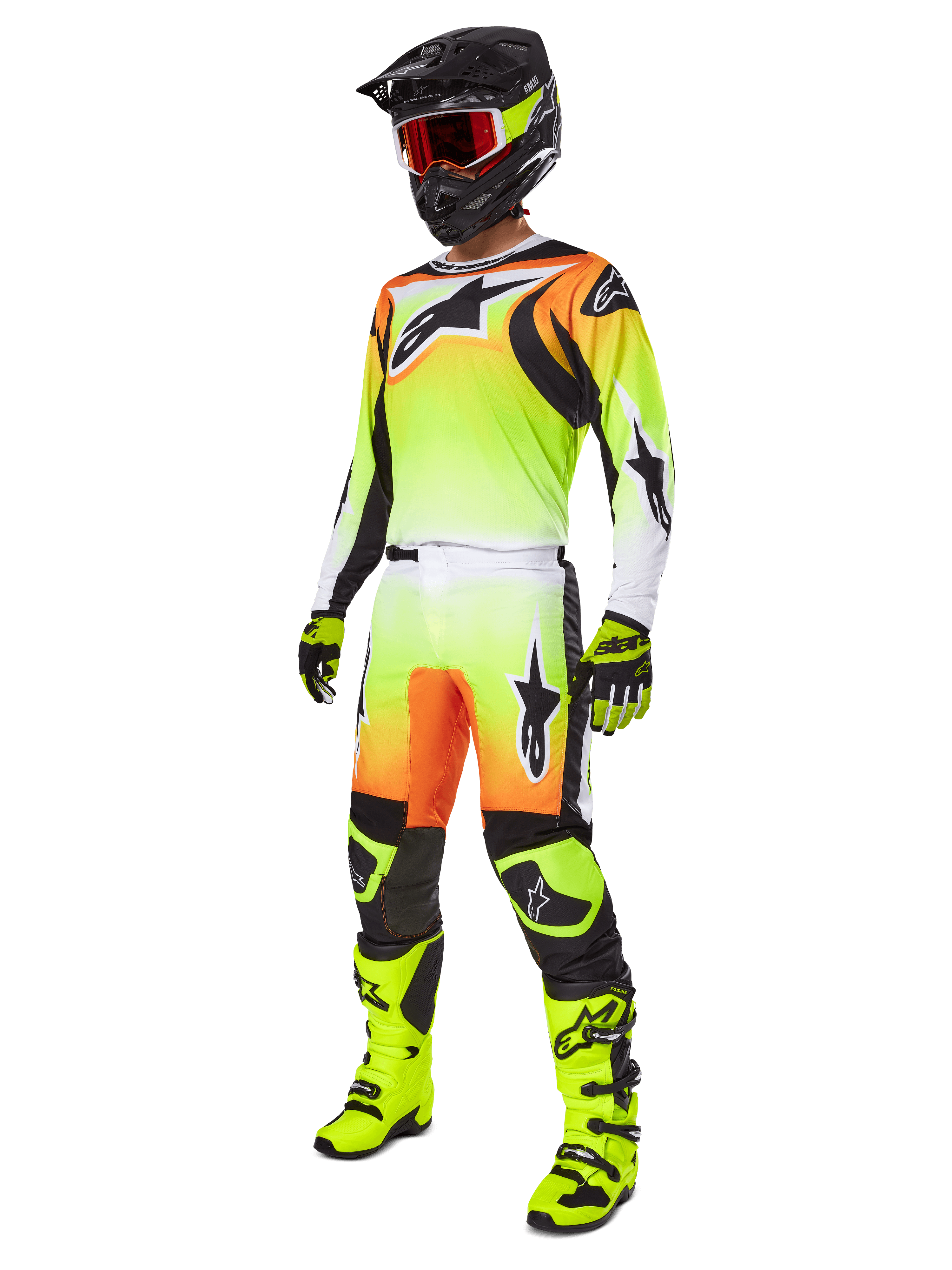 Motocross rider wearing the Alpinestars 2025 Fluid Wurx Pants in Yellow and Black, featuring a vibrant yellow-to-white gradient with orange and black accents, shown as part of a complete racing gear set with a matching jersey, black helmet, and neon yellow boots.