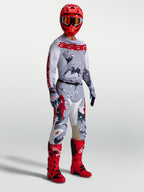 Alpinestars Racer Air Lone Pants and gear set, men's gray camo and red motocross outfit with matching jersey and red boots.