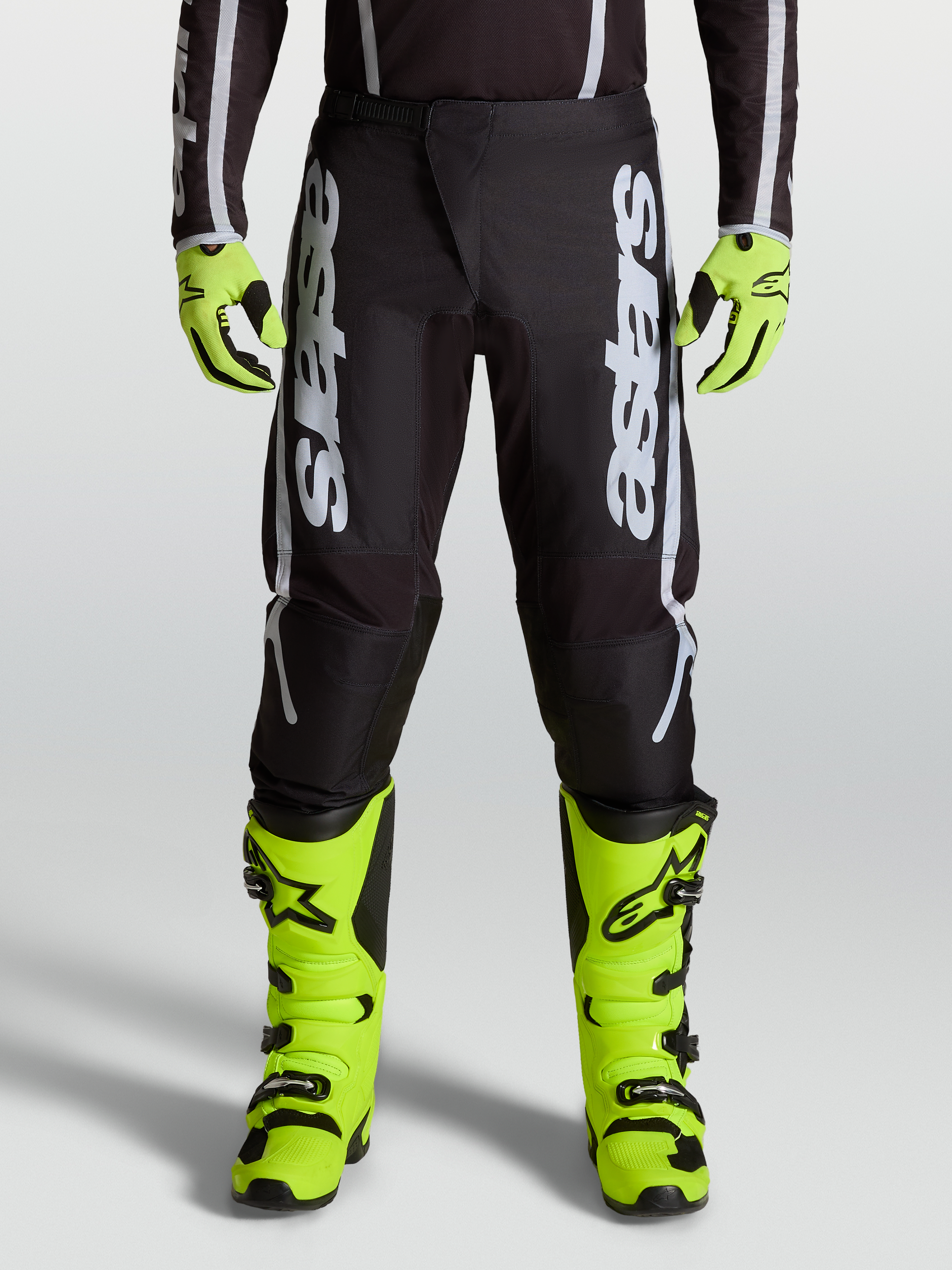 Alpinestars Fluid Apex V2 Pants, professional motocross performance pants in Black and Silver with ergonomic stretch panels.