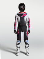 Alpinestars 2027 Fluid Drag Pants, black and white motocross gear with red and light blue accents, shown as a full gear set.