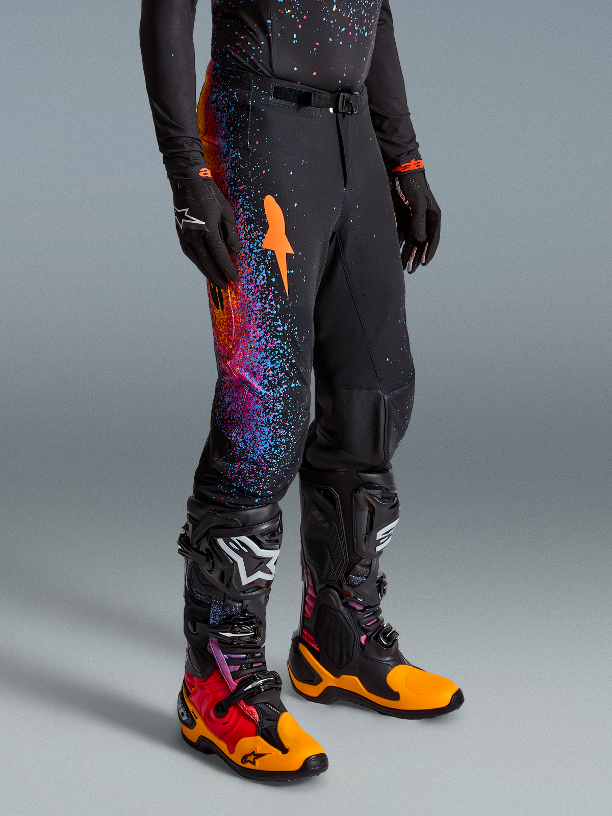 Alpinestars Limited Edition Supertech Black Hole Pants AND Gear Set in Black with vibrant orange and purple cosmic graphics.