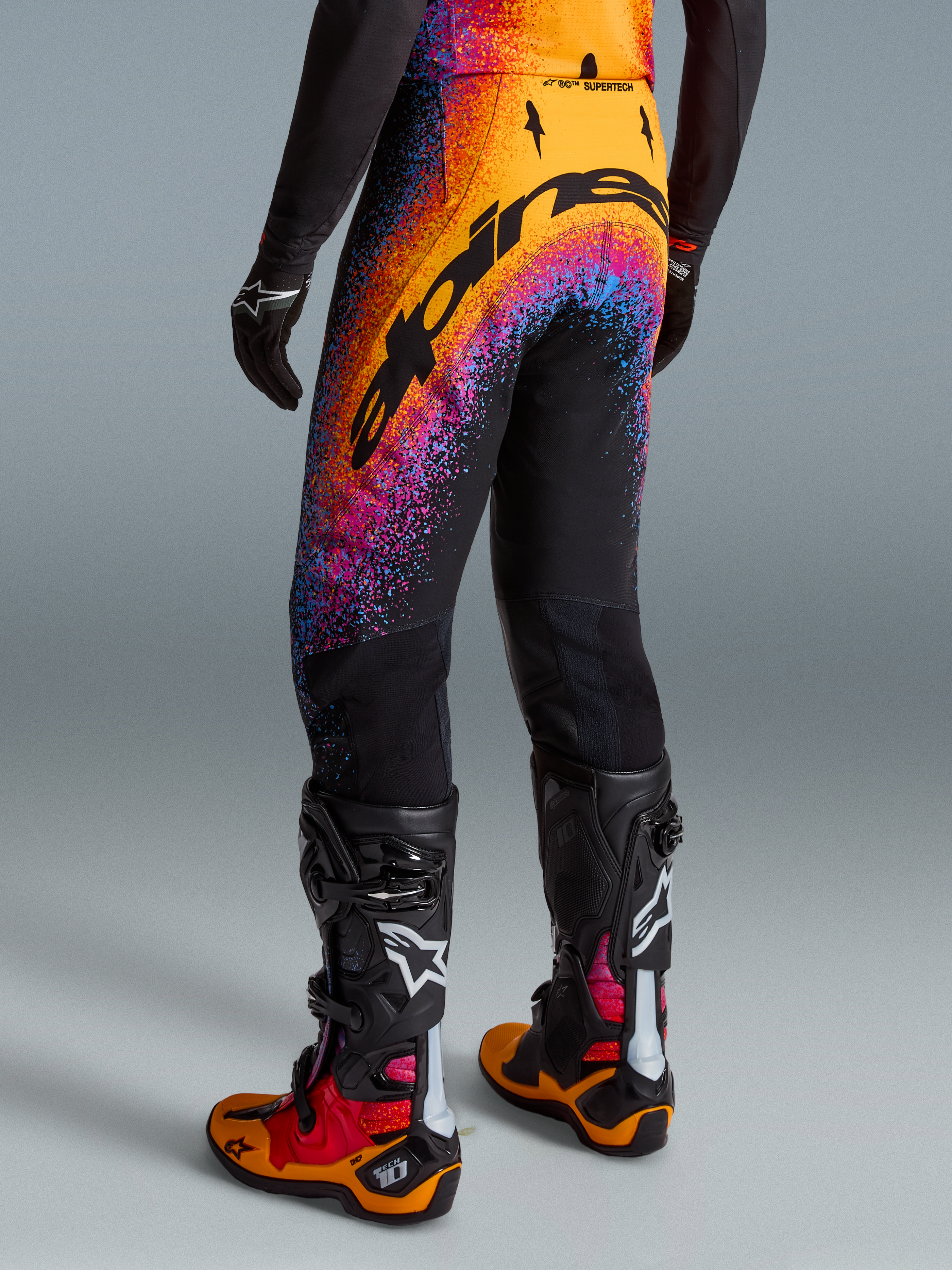 Alpinestars Limited Edition Supertech Black Hole Pants, Men's Motocross Gear, Black with Orange and Purple, Rear View.