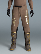 Alpinestars Limited Edition Supertech Air Gold Pants, Brown and Gold Motocross Gear on-model with Tech 10 boots.