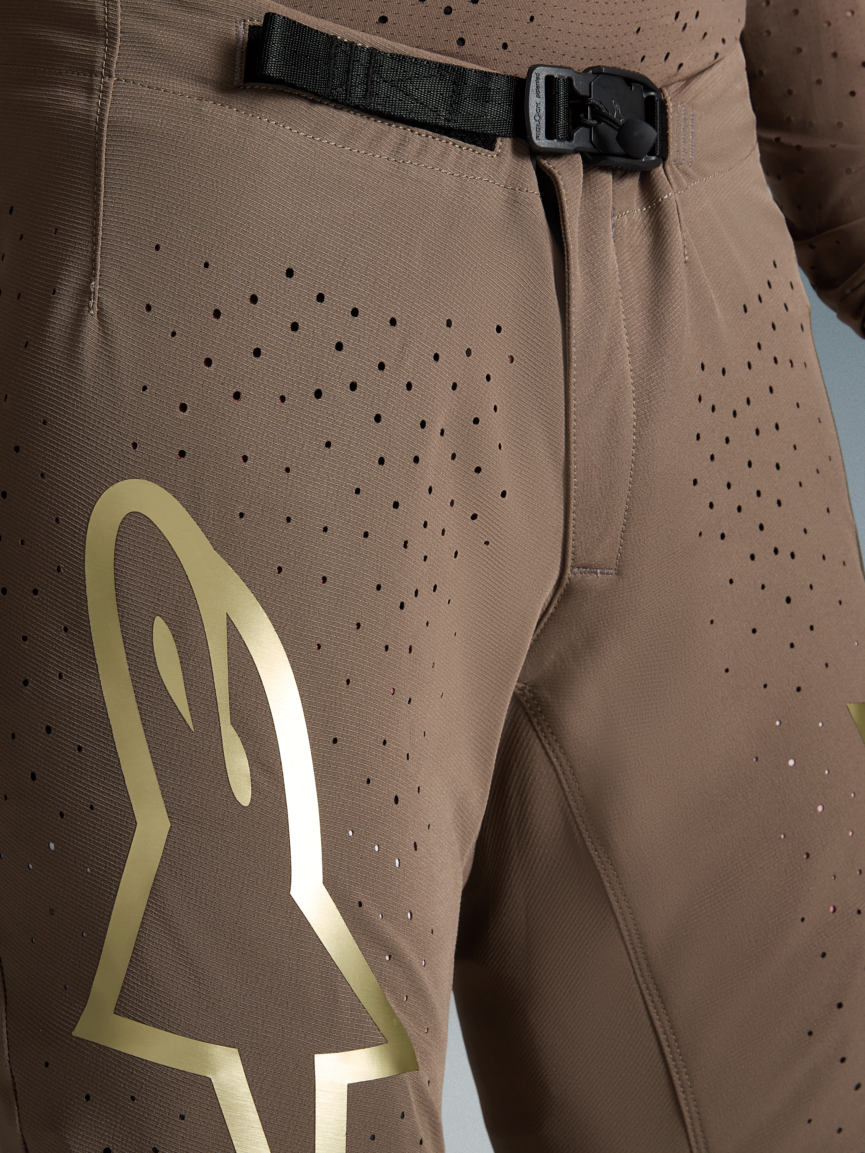 Alpinestars Supertech Air Gold Motocross Pants, Brown and Gold, ventilated stretch fabric with SX1 magnetic buckle.