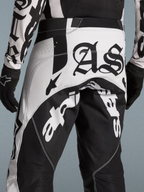 Alpinestars Limited Edition Techstar Wolf Dust Motocross Pants in Black and White with Gothic AS branding and vented panels.