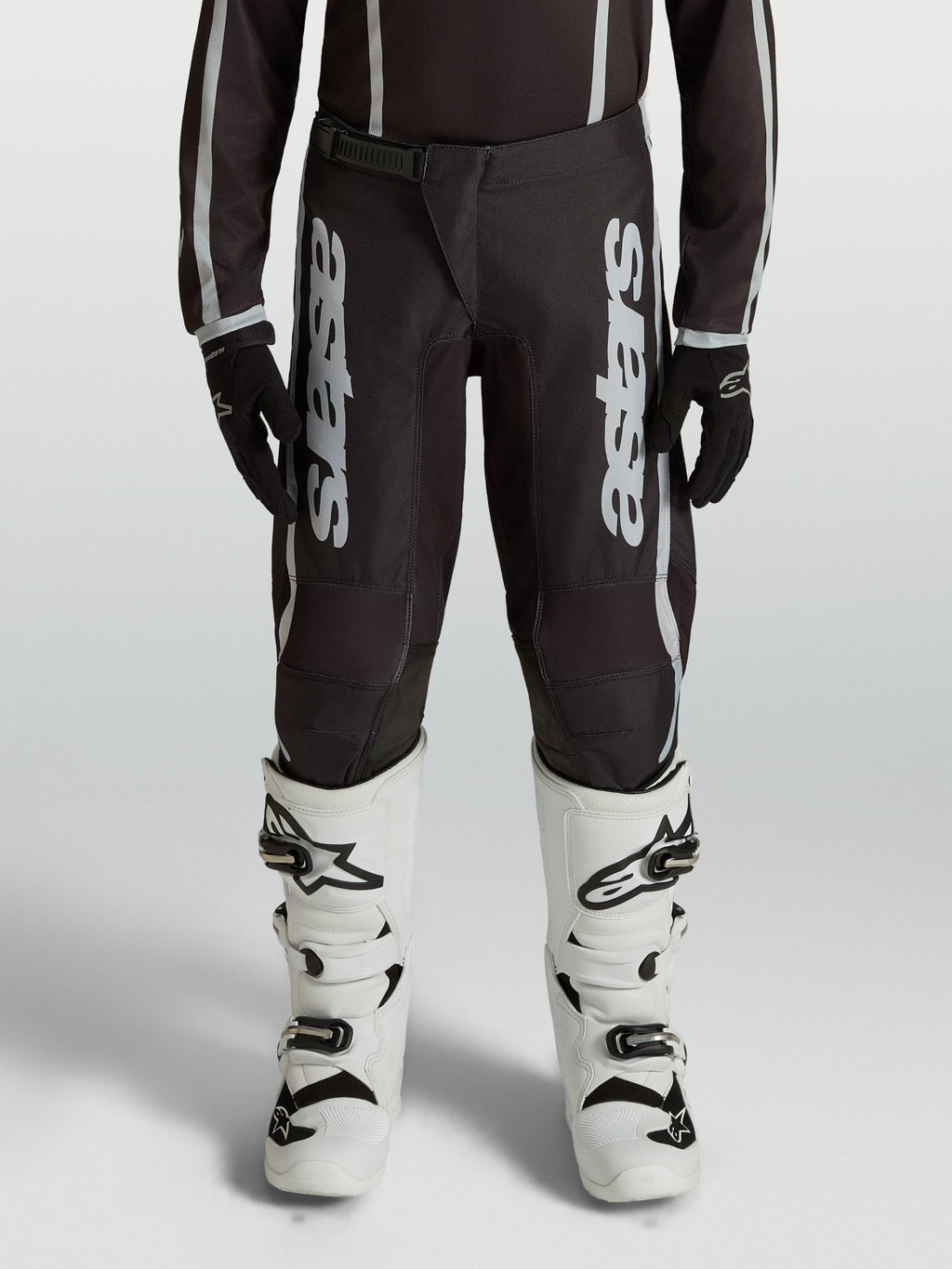 Alpinestars Youth Fluid Apex V2 Motocross Pants, Black and Silver, durable 600D polyfabric with ergonomic pre-curved legs.