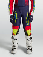 Alpinestars Youth Fluid Drag Pants for Motocross Racing, Blue Navy and Fire Red with Neon Yellow Graphics.