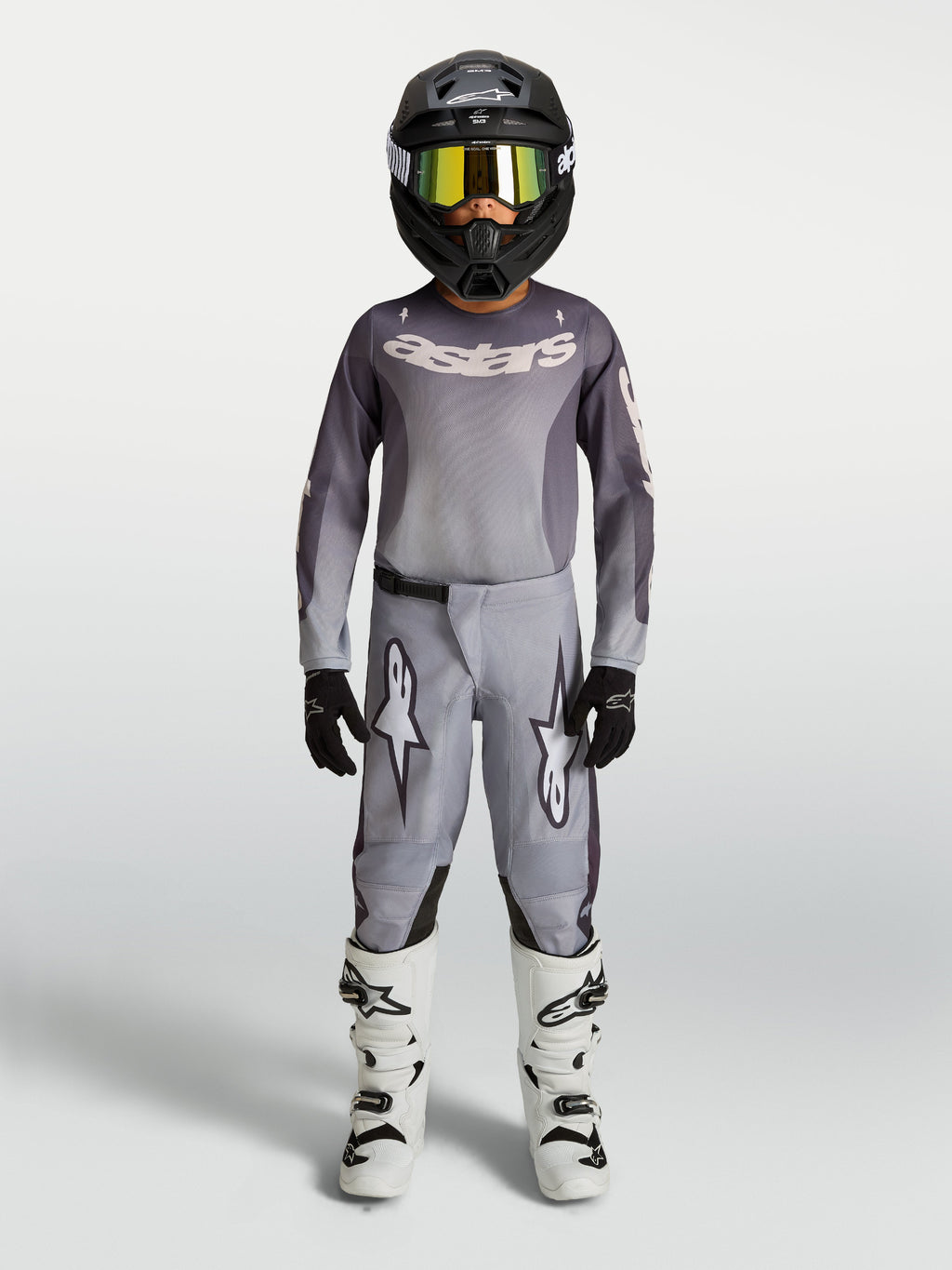 Alpinestars Youth Fluid Amber Pants, Gray and Sand 600D textile motocross pants for youth, shown with matching gear.