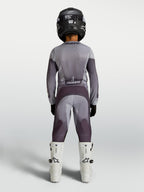 Alpinestars Youth Fluid Amber Pants in sand and gray, durable youth motocross pants shown from behind on a rider.