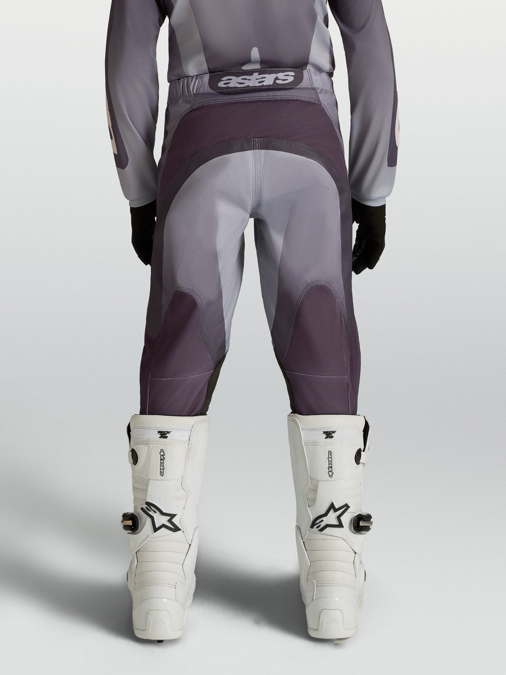 Alpinestars Youth Fluid Amber Motocross Pants in gray and sand with reinforced seat and ergonomic stretch panels.