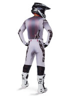 Alpinestars 2025 Supertech Maker Jersey, Motocross Jersey, Silver and Black, rear view on a rider wearing matching gear and white boots, featuring bold Alpinestars branding on sleeves and a star logo on the back, athletic race fit for professional off-road performance.