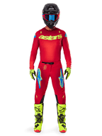 Motocross rider wearing the Alpinestars 2025 Supertech Maker Jersey and matching pants in Bright Red and Yellow Fluo, featuring yellow 'astars' branding on the chest, black helmet with blue goggles, yellow-fluo gloves and boots, complete professional racing outfit for off-road performance.