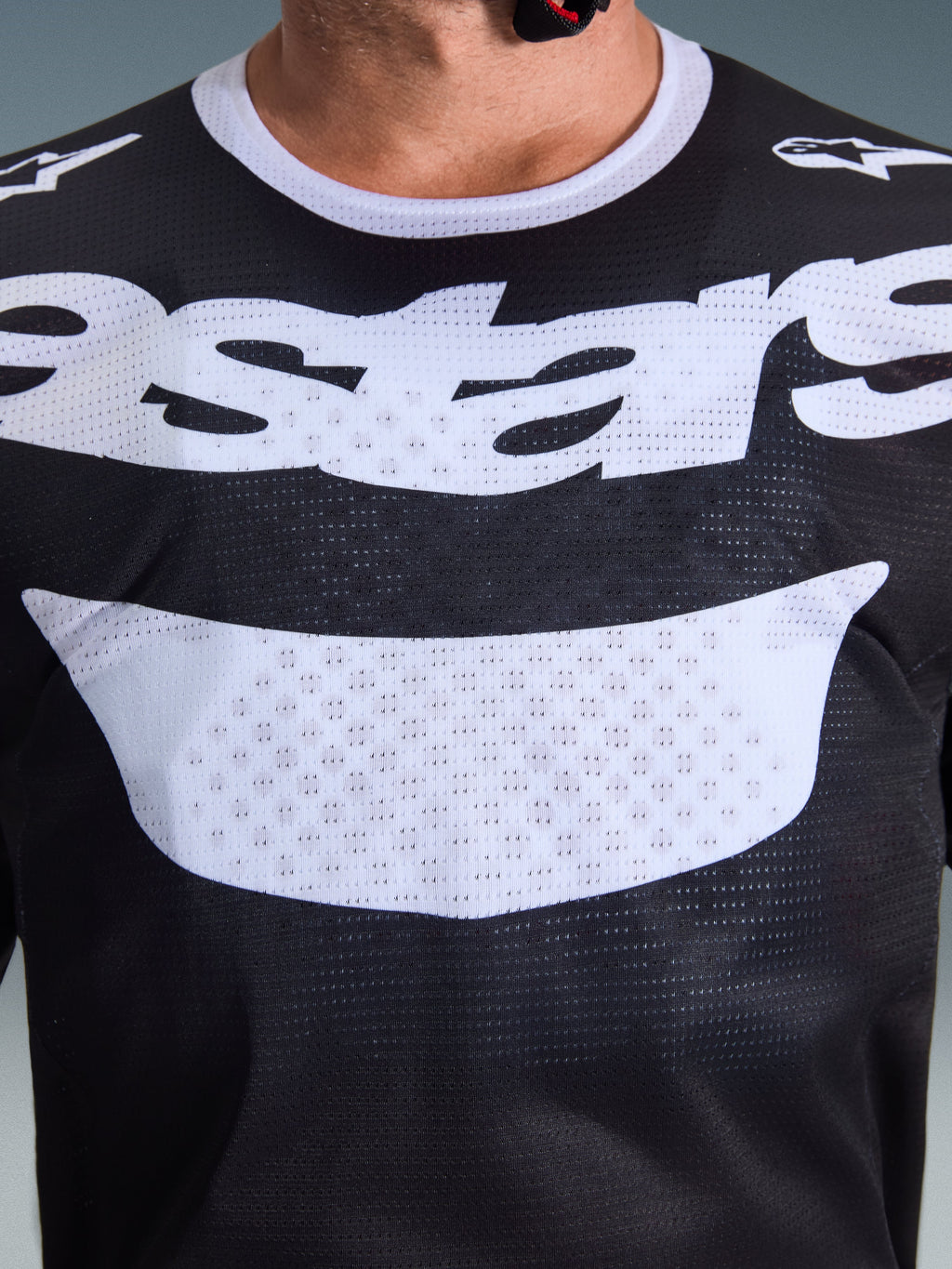 Alpinestars 2026 Racer Air Riway Jersey, Motocross Jersey, Black and White, close-up view of chest with large white logo, detailed mesh airflow fabric texture, technical breathable gear for off-road riding