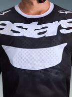 Alpinestars 2026 Racer Air Riway Jersey, Motocross Jersey, Black and White, close-up view of chest with large white logo, detailed mesh airflow fabric texture, technical breathable gear for off-road riding