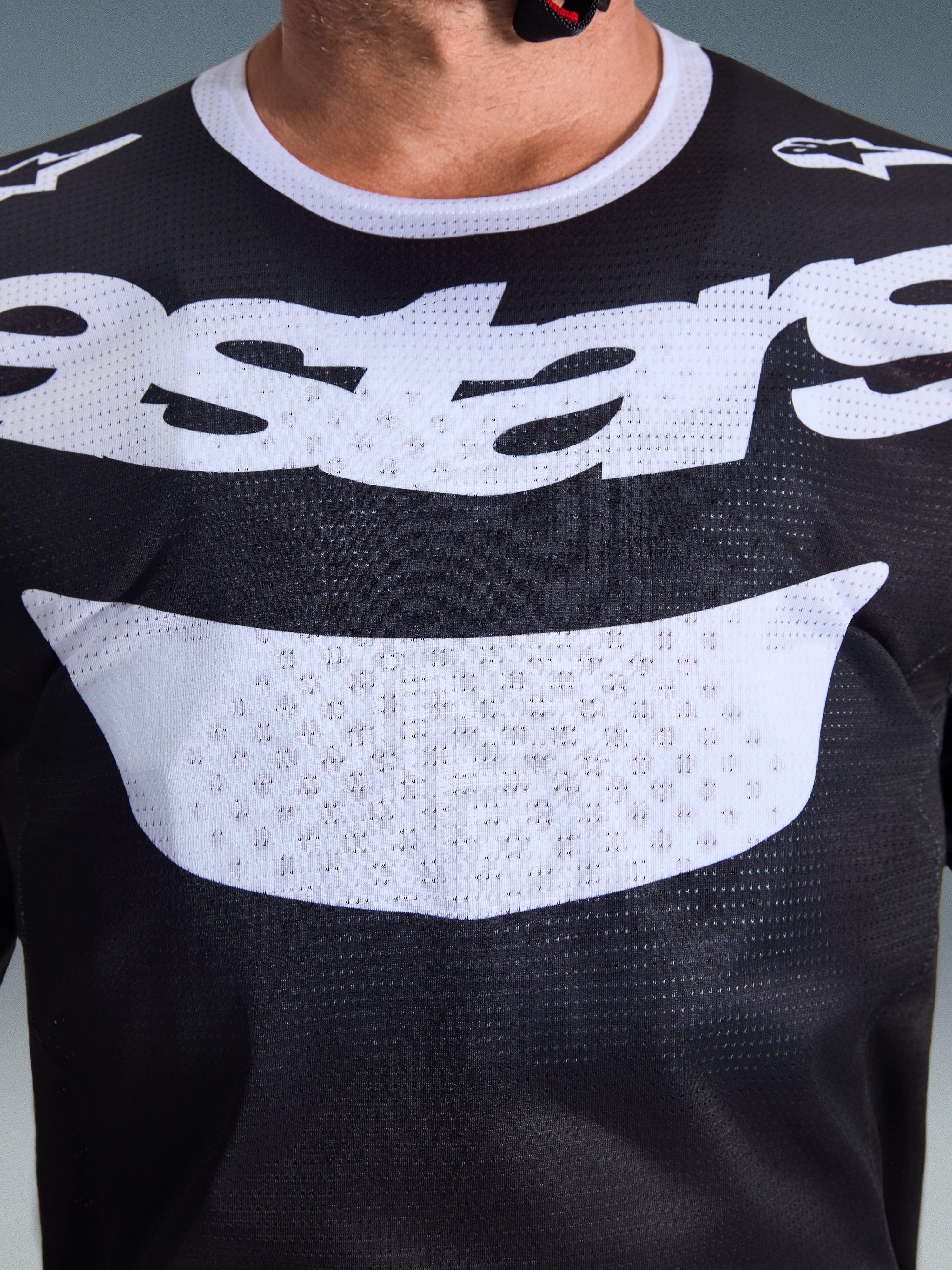 Alpinestars 2026 Racer Air Riway Jersey, Motocross Jersey, Black and White, close-up view of chest with large white logo, detailed mesh airflow fabric texture, technical breathable gear for off-road riding