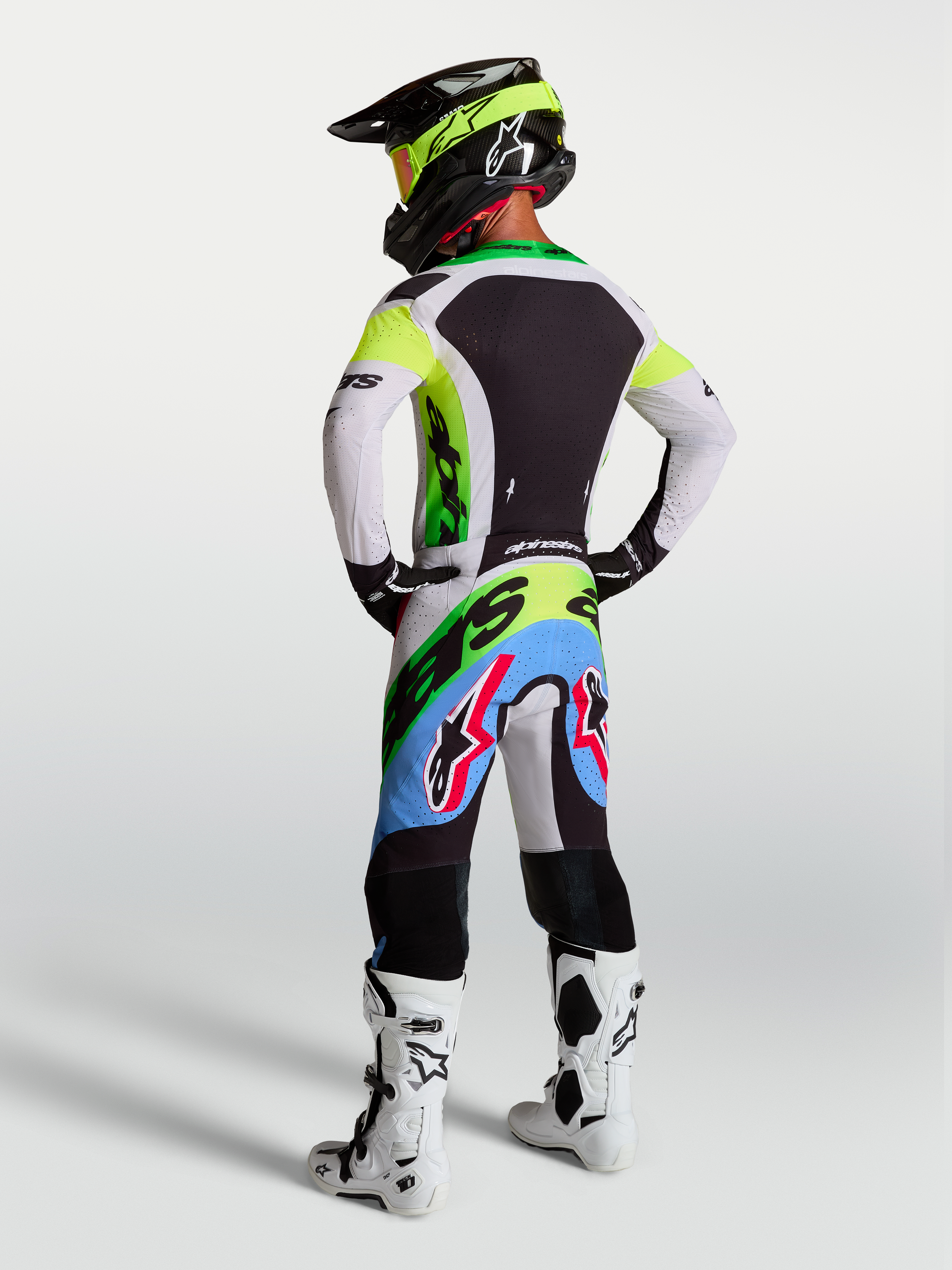 Alpinestars Supertech Dyna Jersey and Gear Set, men's motocross gear in green fluo and lilac, rear view.