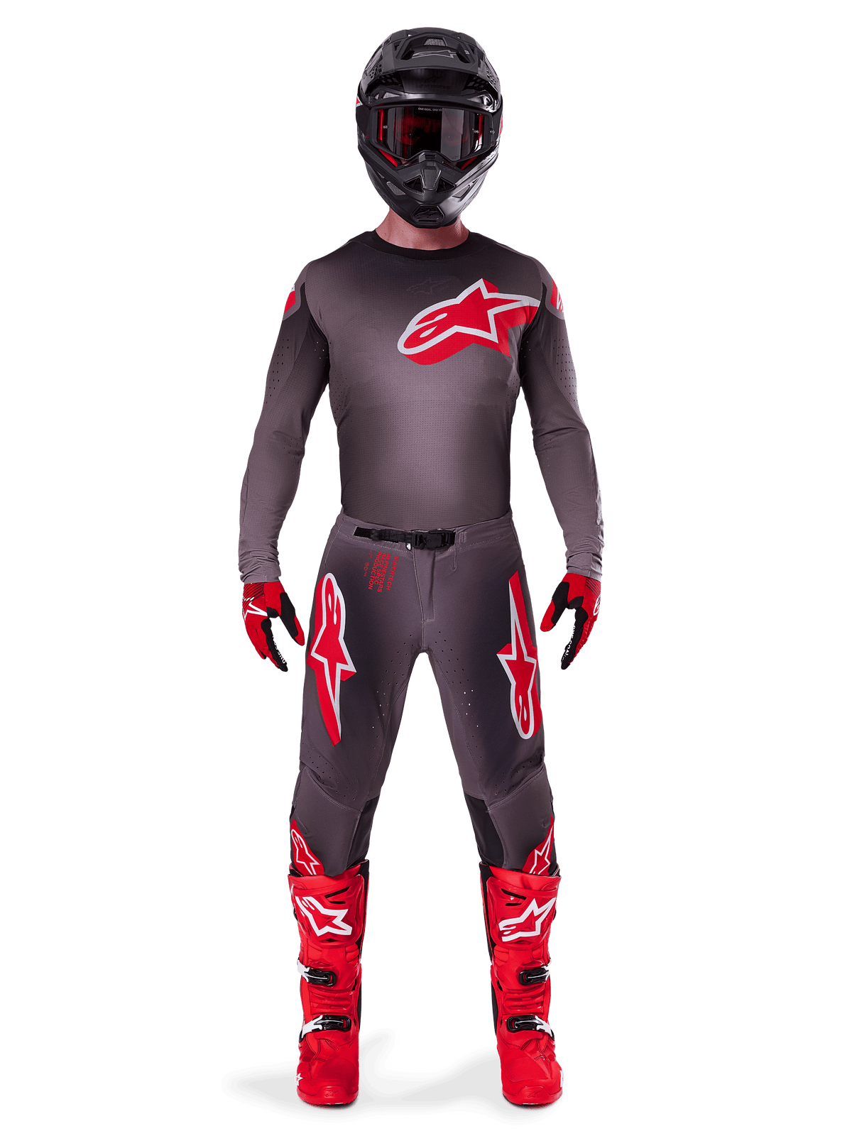 Motocross rider wearing complete racing gear, 2025 Supertech Lipan Jersey in Smoke Bright Red, matching grey pants with red logos, bright red boots, black helmet with goggles, and red and black gloves, professional motocross outfit.