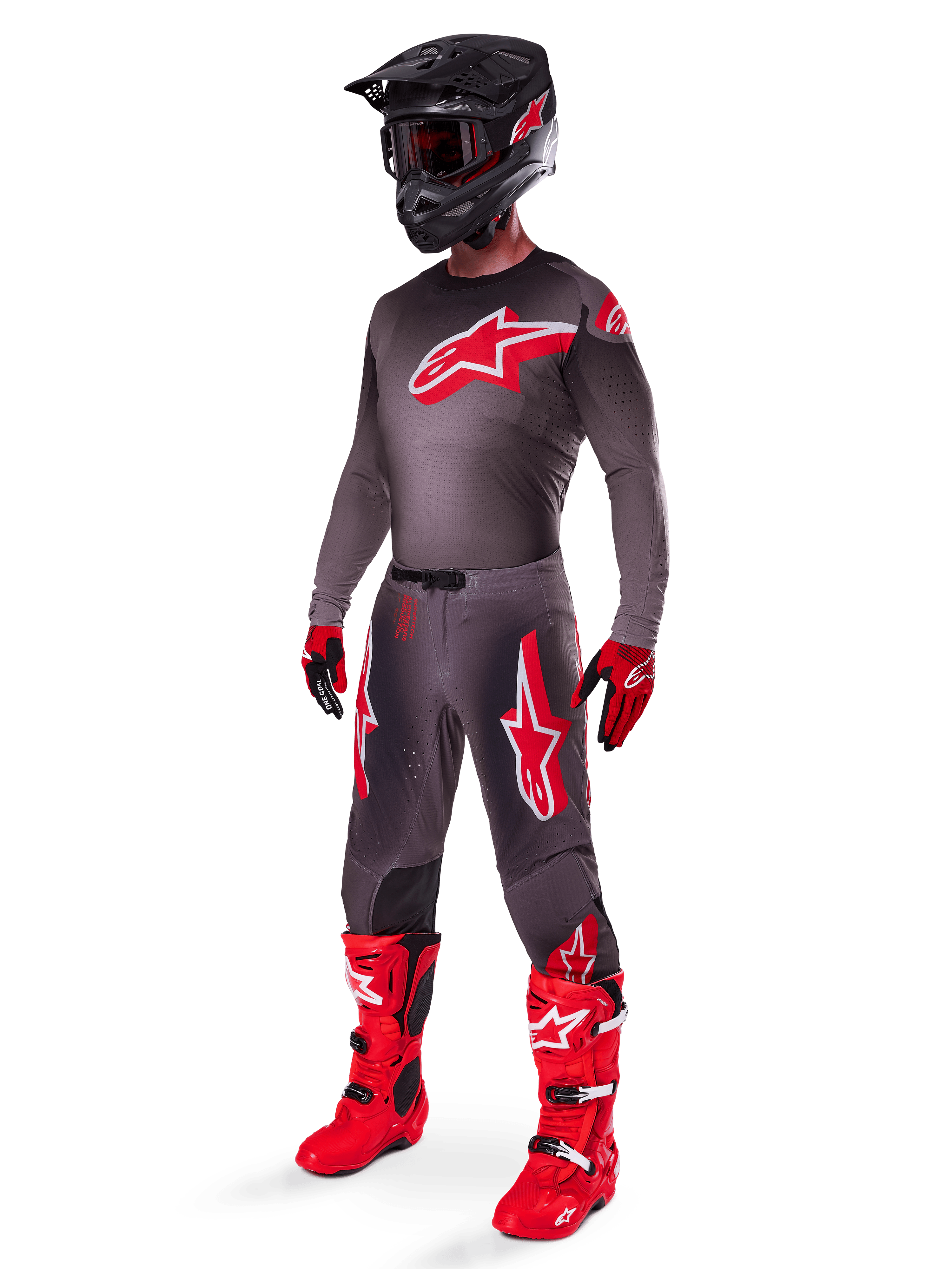 Motocross rider wearing complete racing gear, Smoke Bright Red 2025 Supertech Lipan Jersey, matching grey pants with red graphics, black helmet with red accents, bright red boots, and red and black gloves, coordinated professional outfit for off-road racing