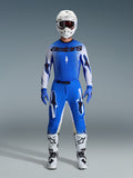 Motocross rider wearing the Alpinestars 2026 Supertech Scenz Gear Set in Ucla Blue and White, featuring a lightweight blue and white jersey with black branding, matching blue pants, white racing helmet, and white motocross boots, pro-level performance gear for off-road racing.