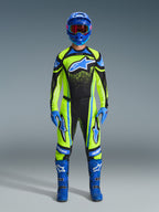 Motocross rider wearing complete racing gear, 2026 Techstar Nomur Jersey in yellow fluo and dark navy, matching motocross pants, blue helmet with red-tinted goggles, blue gloves, and blue boots, coordinated professional outfit for off-road racing