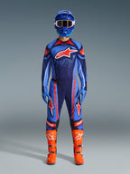 Motocross rider wearing the Alpinestars 2026 Techstar Nomur Jersey in Dark Navy, Orange, and UCLA Blue, paired with matching motocross pants, a blue helmet with goggles, and bright orange racing boots, full coordinated off-road competition gear